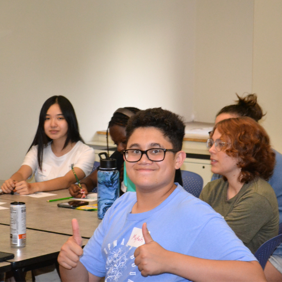 UB student smiles in a classroom.