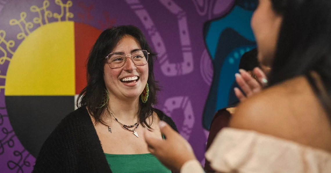 Alum Marissa Joly laughs with a current student.