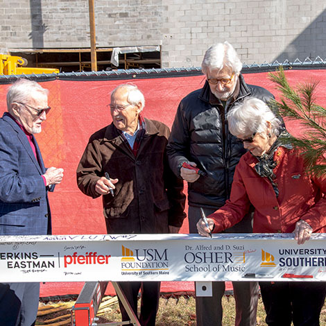 Dan Crewe '22H, Peter Plumb, Tom Chappell '12H, and Kate Cheney Chappell '83 & '12H sign the final structural beam for our Crewe Center for the Arts.
