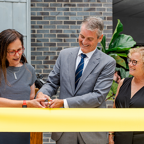 President Jacqueline Edmondson, former president Glenn Cummings, and his wife cut the ribbon at the dedication ceremony of our Dr. Glenn A. Cummings Courtyard.