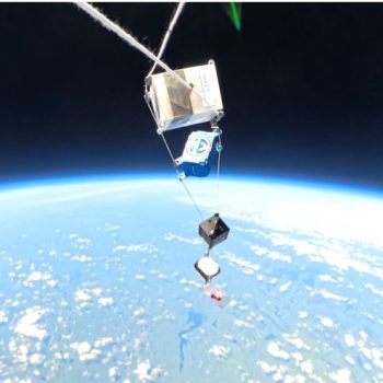A group of CubeSats attached to a high altitude weather balloon, with Earth in the background