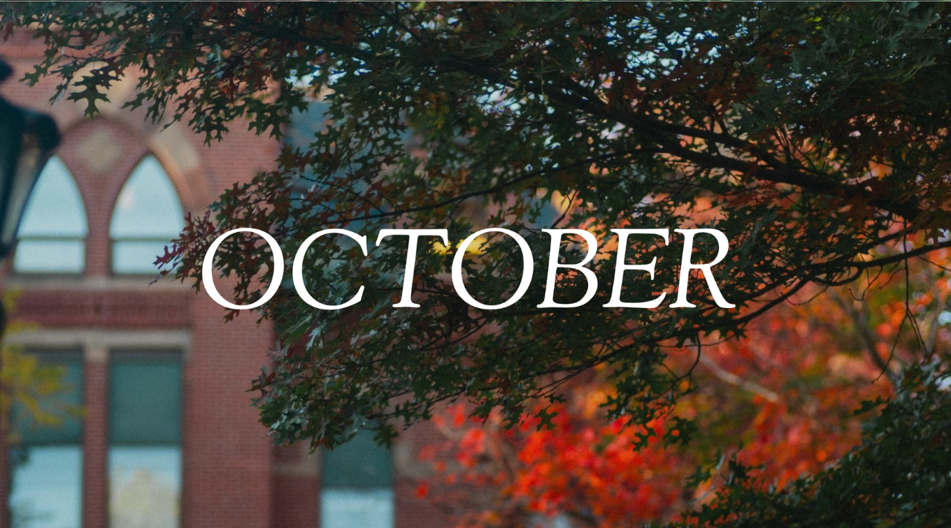 "OCTOBER" text overlaid on red and orange fall foliage framing historic brick building on USM campus